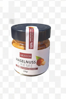 ARISTOS Haselnusscreme im 220-Gramm-Glas vor kariertem Hintergrund